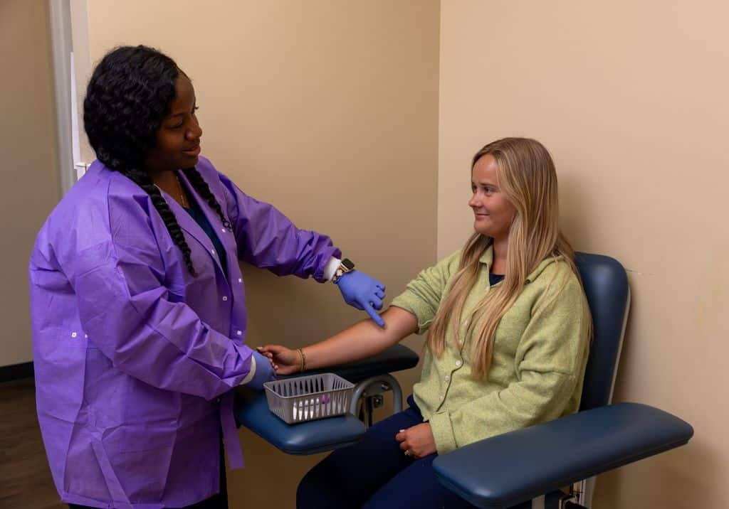 Nurse performing a gentle blood draw for a patient at Gadsden Cancer Clinic